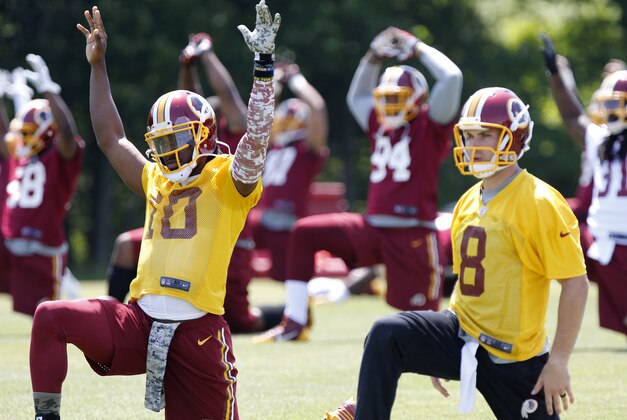 May 26, 2015; Ashbury, VA, USA; Washington Redskins quarterback Robert Griffin III (10) and Redskins quarterback Kirk Cousins (8) warm up during the Redskins OTA at Redskins Park. Mandatory Credit: Geoff Burke-USA TODAY Sports