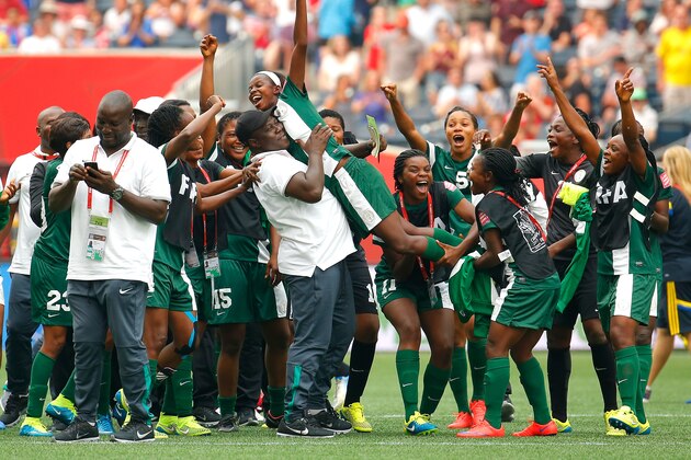 WINNIPEG, MB - JUNE 08:  Ngozi Okobi #13 of Nigeria is lifted above her teammates after being selected for the Player of the Match Award in their 3-3 tie with Sweden in the FIFA Women's World Cup Canada 2015 Group D match between Sweden and Nigeria at Winnipeg Stadium on June 8, 2015 in Winnipeg, Canada.  (Photo by Kevin C. Cox/Getty Images)