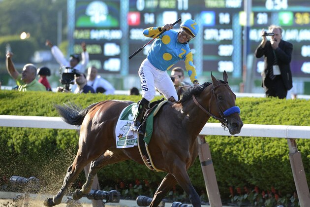 Victor Espinoza reacts after crossing the finish line with American Pharoah (5) to win the 147th running of the Belmont Stakes horse race at Belmont Park, Saturday, June 6, 2015, in Elmont, N.Y.  American Pharoah is the first horse to win the Triple Crown since Affirmed won it in 1978.(AP Photo/Bill Kostroun)