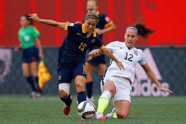 WINNIPEG, MB - JUNE 08:  Katrina Gorry #19 of Australia challenges Lauren Holiday #12 of United States in the first half during the FIFA Women's World Cup 2015 Group D match at Winnipeg Stadium on June 8, 2015 in Winnipeg, Canada.  (Photo by Kevin C. Cox/Getty Images)