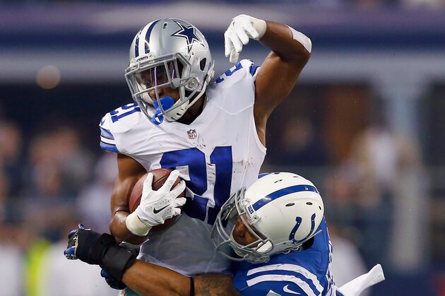 ARLINGTON, TX - DECEMBER 21:  Joseph Randle #21 of the Dallas Cowboys carries the ball against  Jerrell Freeman #50 of the Indianapolis Colts at AT&T Stadium on December 21, 2014 in Arlington, Texas.  (Photo by Tom Pennington/Getty Images)