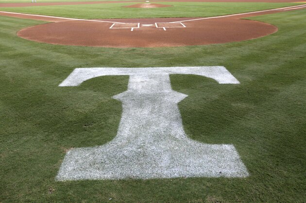 The Texas Rangers logo is shown behind the batters box before a baseball game against the Tampa Bay Rays Tuesday, Aug. 28, 2012, in Arlington, Texas. The Rangers won 1-0. (AP Photo/Tony Gutierrez)