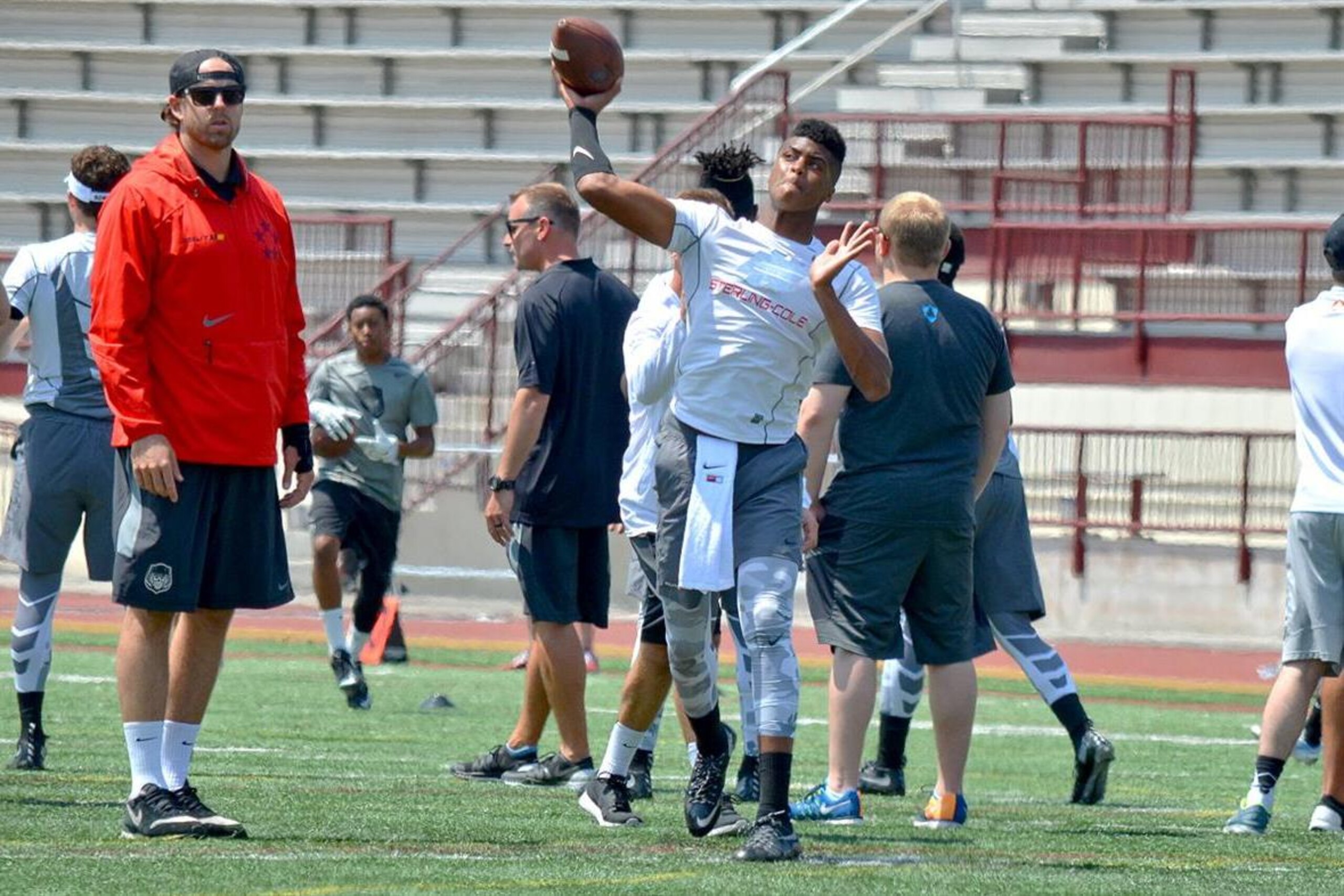 Quarterback Dillon Sterling-Cole makes a throw during the Elite 11 semifinals in Los Angeles, as Elite 11 coach Jordan Palmer watches on. Sterling-Cole has a top eight but isn't in any rush to make a verbal commitment.
