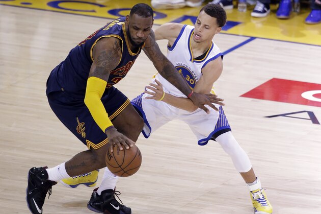 Cleveland Cavaliers forward LeBron James, left, is guarded by Golden State Warriors guard Stephen Curry during the second half of Game 2 of basketball's NBA Finals in Oakland, Calif., Sunday, June 7, 2015. (AP Photo/Eric Risberg)