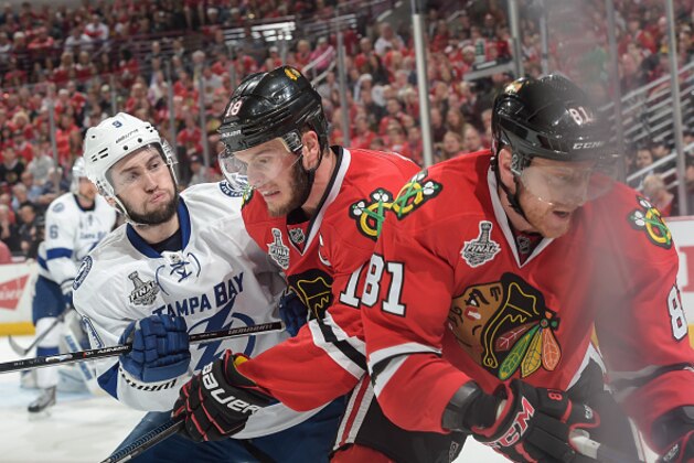 CHICAGO, IL - JUNE 08:  Marian Hossa #81 of the Chicago Blackhawks reaches for the puck as Tyler Johnson #9 of the Tampa Bay Lightning pushes into Jonathan Toews #19 during Game Three of the 2015 NHL Stanley Cup Final at the United Center on June 8, 2015 in Chicago, Illinois.  (Photo by Bill Smith/NHLI via Getty Images)