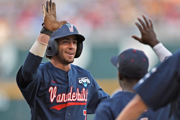 Omaha, NE - JUNE 23:  Second basemen Dansby Swanson #7 of the Vanderbilt Commodores celebrates with his teammates after scoring against the Virginia Cavaliers in the third inning during game one of the College World Series Championship on June 23, 2014 at TD Ameritrade Park in Omaha, Nebraska.  (Photo by Peter Aiken/Getty Images)