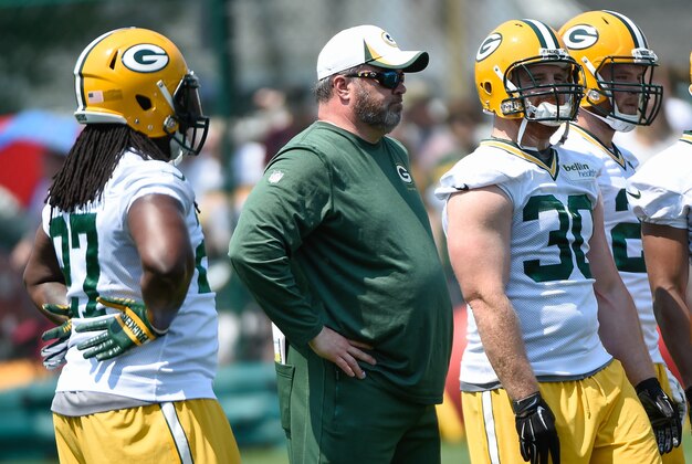 May 28, 2015; Green Bay, WI, USA; Green Bay Packers head coach Mike McCarthy (center) watches team during Rookie Orientation Camp and Organized Team Activities at the Don Hutson Center in Green Bay. Mandatory Credit: Benny Sieu-USA TODAY Sports