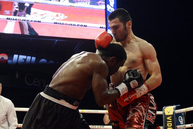 Sep 27, 2014; Montreal, Quebec, Canada; Artur Beterbiev (red trunks) and Tavoris Cloud (black trunks) box during the first round of their light heavyweight NABA championship fight at the Bell Centre. Mandatory Credit: Eric Bolte-USA TODAY Sports