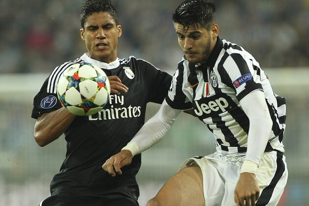 TURIN, ITALY - MAY 05:  Alvaro Morata (R) of Juventus FC competes for the ball with Raphael Varane (L) of Real Madrid CF during the UEFA Champions League semi final match between Juventus and Real Madrid CF at Juventus Arena on May 5, 2015 in Turin, Italy.  (Photo by Marco Luzzani/Getty Images)