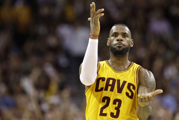 Cleveland Cavaliers forward LeBron James (23) celebrates a play against the Golden State Warriors during the second half of Game 3 of basketball's NBA Finals in Cleveland, Tuesday, June 9, 2015. (AP Photo/Tony Dejak)