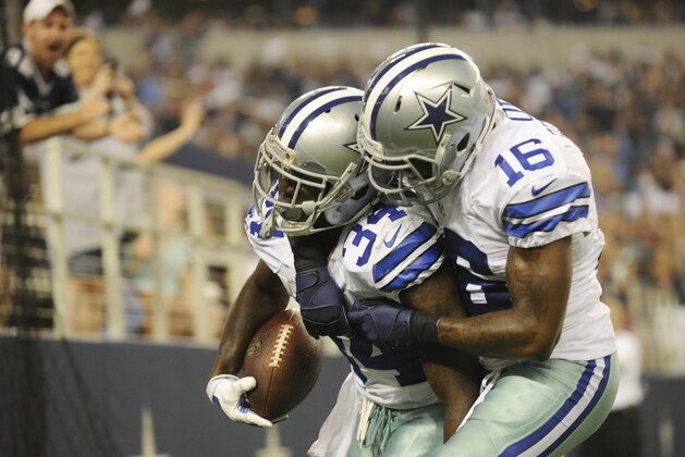 Dallas Cowboys running back Ryan Williams (34) celebrates a touchdown with wide receiver Tim Benford (16) during the second half of an NFL preseason football game against the Baltimore Ravens, Saturday, Aug. 16, 2014, in Arlington, Texas. (AP Photo/Matt Strasen)