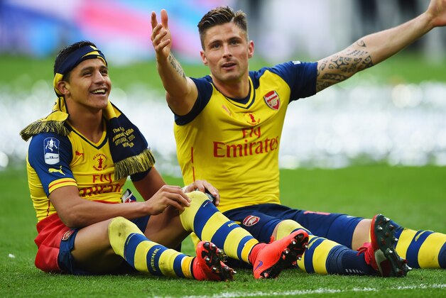 LONDON, ENGLAND - MAY 30:  Alexis Sanchez and Olivier Giroud of Arsenal celebrate victory after the FA Cup Final between Aston Villa and Arsenal at Wembley Stadium on May 30, 2015 in London, England. Arsenal beat Aston Villa 4-0.  (Photo by Shaun Botterill/Getty Images)