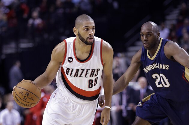 Portland Trail Blazers forward Nicolas Batum, from France, left, drives past New Orleans Pelicans forward Quincy Poindexter during the first half of an NBA basketball game in Portland, Ore., Saturday, April 4, 2015.  (AP Photo/Don Ryan)