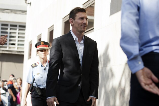 Barcelona F.C. soccer player Lionel Messi, centre  arrives at a court to answer questions in a tax fraud case,  in Gava, near Barcelona, Spain, Friday, Sept. 27, 2013. Barcelona star Lionel Messi and his father are appearing before a Spanish judge to answer questions in a tax fraud case. A complaint lodged by a Spanish state prosecutor in June said Messi and his father tried to conceal earnings from the player's image rights. The complaint alleged the Argentina international owed 4 million euros ($5.3 million) in back taxes from 2007, 2008 and 2009. (AP Photo/Paco Serinelli)
