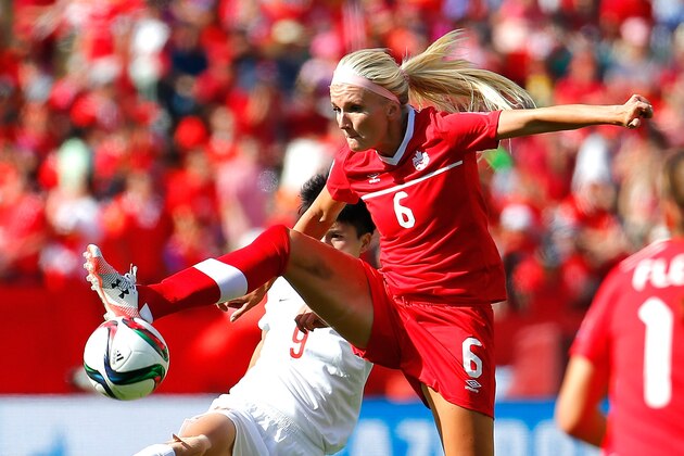 EDMONTON, AB - JUNE 06:  Kaylyn Kyle #6 of Canada makes a play on the ball against Wang Shanshan #9 of China PR during the FIFA Women's World Cup Canada 2015 Group A match between Canada and China PR at Commonwealth Stadium on June 6, 2015 in Edmonton, Canada.  (Photo by Kevin C. Cox/Getty Images)