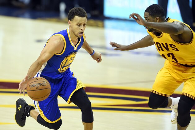 Jun 9, 2015; Cleveland, OH, USA; Golden State Warriors guard Stephen Curry (30) drives against Cleveland Cavaliers center Tristan Thompson (13) during the first quarter of game three of the NBA Finals at Quicken Loans Arena. Mandatory Credit: David Richard-USA TODAY Sports