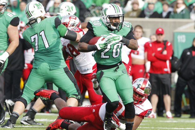 Nov 28, 2014; Huntington, WV, USA; Marshall Thundering Herd running back Steward Butler (20) runs the ball against the Western Kentucky Hiltoppers during the first half at Joan C. Edwards Stadium. Mandatory Credit: Mark Zerof-USA TODAY Sports