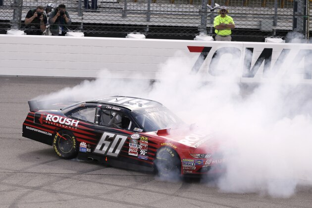 Chris Buescher does a burnout after winning the NASCAR Xfinity Series auto race, Sunday, May 17, 2015, at Iowa Speedway in Newton, Iowa. (AP Photo/Charlie Neibergall)