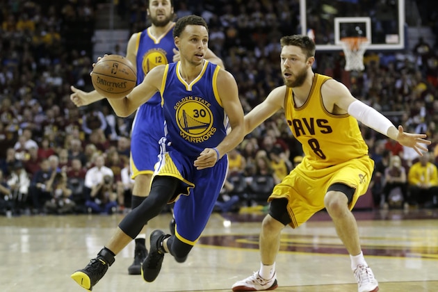 Golden State Warriors guard Stephen Curry (30) drives on Cleveland Cavaliers guard Matthew Dellavedova (8) during the second half of Game 3 of basketball's NBA Finals in Cleveland, Tuesday, June 9, 2015. (AP Photo/Tony Dejak)