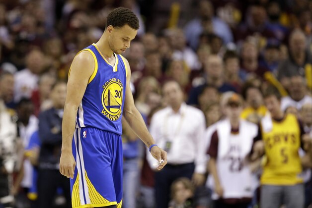 Golden State Warriors guard Stephen Curry (30) walks down the court with his head down in the closing seconds of Game 3 of basketball's NBA Finals against the Cleveland Cavaliers in Cleveland, Tuesday, June 9, 2015. The Cavaliers defeated the Warriors 96-91. AP Photo/Tony Dejak)