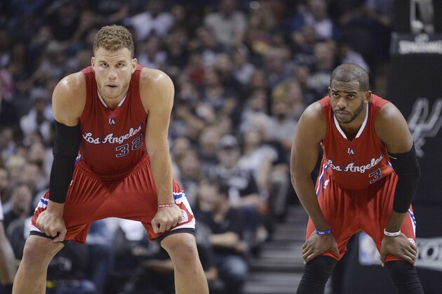 Los Angeles Clippers' Blake Griffin (32) and Chris Paul (3) wait for play to resume during the first half of Game 3 in an NBA basketball first-round playoff series against the San Antonio Spurs, Friday, April 24, 2015, in San Antonio. (AP Photo/Darren Abate)