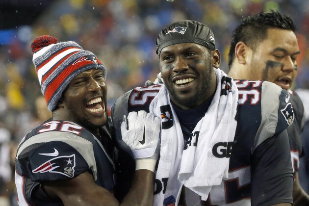 New England Patriots defensive end Chandler Jones (95) celebrates with teammate Devin McCourty during the second half of the NFL football AFC Championship game against the Indianapolis Colts Sunday, Jan. 18, 2015, in Foxborough, Mass. (AP Photo/Elise Amendola)