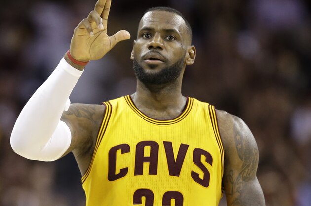 Cleveland Cavaliers forward LeBron James (23) celebrates a play against the Golden State Warriors during the second half of Game 3 of basketball's NBA Finals in Cleveland, Tuesday, June 9, 2015. (AP Photo/Tony Dejak)
