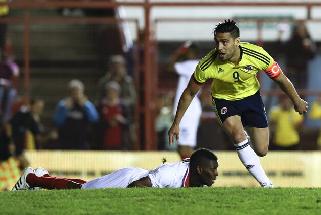 Colombia's Radamel Falcao Garcia celebrates scoring as he runs past a fallen Keyner Brown of Costa Rica, during a friendly soccer match in Buenos Aires, Argentina, Saturday, June 6, 2015.(AP Photo/Natacha Pisarenko)