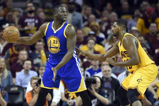 Jun 9, 2015; Cleveland, OH, USA; Golden State Warriors forward Draymond Green (23) handles the ball against Cleveland Cavaliers center Tristan Thompson (13) during the third quarter in game three of the NBA Finals at Quicken Loans Arena. Mandatory Credit: Bob Donnan-USA TODAY Sports