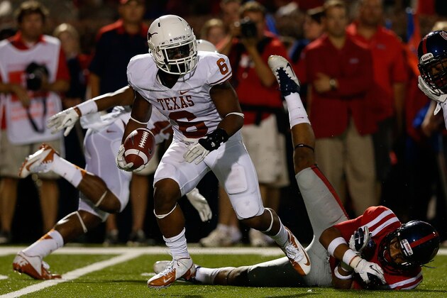 OXFORD, MS - SEPTEMBER 15:  Quandre Diggs #6 of the Texas Longhorns hauls in an interception in front of Donte Moncrief #12 of the Ole Miss Rebels at Vaught-Hemingway Stadium on September 15, 2012 in Oxford, Mississippi.  (Photo by Scott Halleran/Getty Images)