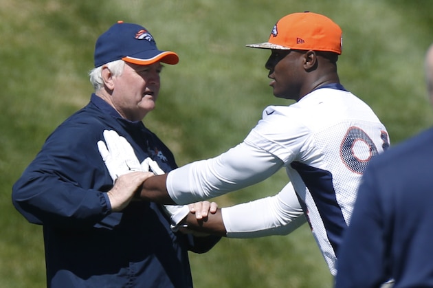 Denver Broncos defensive coordinator Wade Phillips, left, instructs outside linebacker DeMarcus Ware during the second day of the NFL football team's two-day voluntary veterans minicamp Wednesday, April 29, 2015, in Englewood, Colo. (AP Photo/David Zalubowski)