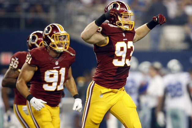 Washington Redskins' Ryan Kerrigan (91) watches as linebacker Trent Murphy (93) celebrates recovering a Dallas Cowboys' Joseph Randle fumble during the first half of an NFL football game, Monday, Oct. 27, 2014, in Arlington, Texas. (AP Photo/Tim Sharp)
