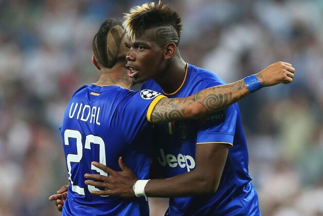 MADRID, SPAIN - MAY 13:  Arturo Vidal of Juventus and Paul Pogba of Juventus celerate following their team's progression to the final during the UEFA Champions League Semi Final, second leg match between Real Madrid and Juventus at Estadio Santiago Bernabeu on May 13, 2015 in Madrid, Spain.  (Photo by Alex Livesey/Getty Images)