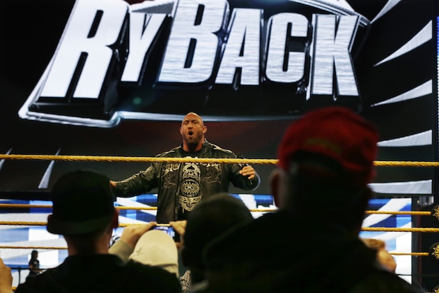 People gather ringside as they listen to professional wrestler Ryan Reeves, known as Ryback, at the Wrestlemania Axxess event Saturday, April 6, 2013, in East Rutherford, N.J., ahead of Sunday's WWE Wrestlemania 29 at MetLife stadium. (AP Photo/Mel Evans)