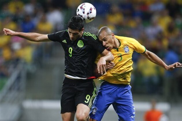 Mexico's Raul Jimenez, left, fights for the ball with Brazil's Miranda during a friendly soccer match in Sao Paulo, Brazil, Sunday, June 7, 2015. Brazil and Mexico are preparing for the Copa America which begins Thursday in Chile. (AP Photo/Andre Penner)