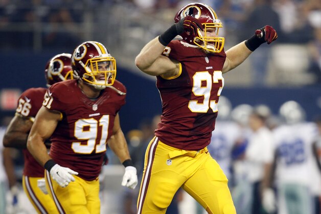Washington Redskins' Ryan Kerrigan (91) watches as linebacker Trent Murphy (93) celebrates recovering a Dallas Cowboys' Joseph Randle fumble during the first half of an NFL football game, Monday, Oct. 27, 2014, in Arlington, Texas. (AP Photo/Tim Sharp)