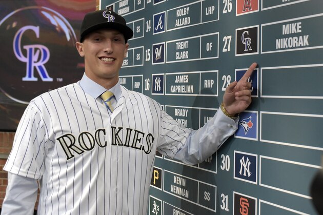 Pitcher Mike Nikorak from Stroudsgurg High School in Stroudsburg, Pa., points to  his name on the board after being selected by the Colorado Rockies with the 27th selection at the 2015 MLB baseball draft Monday, June 8, 2015, in Secaucus, N.J.  (AP Photo/Bill Kostroun)
