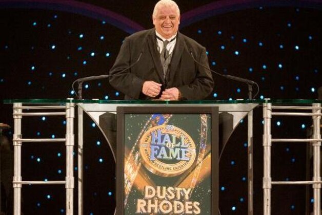 WWE wrestlers Triple H, left, and Kelly Kelly pose photos on the bell podium of the New York Stock Exchange before they ring the opening bell, Wednesday, Oct. 27, 2010, marking 10 years of trading for World Wrestling Entertainment at the NYSE. (AP Photo/Richard Drew)