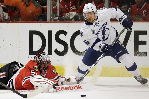Chicago Blackhawks goalie Corey Crawford, left, and Tampa Bay Lightning's Anton Stralman watch a loose puck during the first period in Game 4 of the NHL hockey Stanley Cup Final Wednesday, June 10, 2015, in Chicago. (AP Photo/Nam Y. Huh)