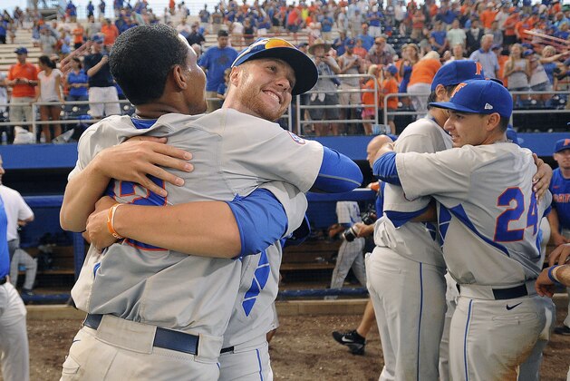 Florida pitcher Logan Shore (32) gets a hug from teammate infielder Richie Martin (12) after Florida defeated Florida State during the NCAA college baseball regional tournament in Gainesville, Fla., Saturday, June, 6, 2015. Florida defeated Florida State 11-4.  (AP Photo/Phil Sandlin)