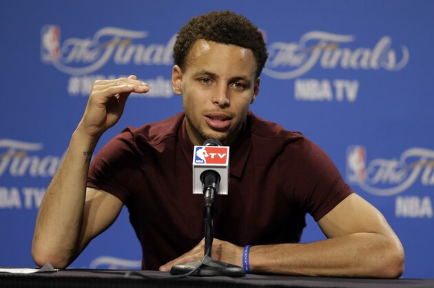 Golden State Warriors guard Stephen Curry (30) answers a question during a press conference following Game 4 of basketball's NBA Finals in Cleveland, early Friday, June 12, 2015. The Warriors defeated the Cleveland Cavaliers 103-82 to tie the best-of-seven game series at 2-2. (AP Photo/Tony Dejak)