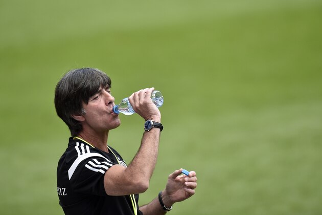 Germany's head coach Joachim Loew drinks water during a training session prior the friendly soccer match between Germany and USA  scheduled for Wednesday  in Cologne, Germany, Tuesday, June 9, 2015. (AP Photo/Martin Meissner)