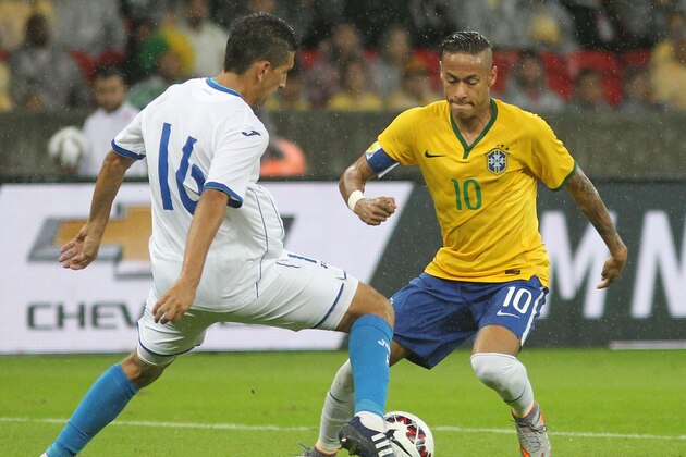 Brazil's Neymar, right, fights for the ball with Honduras' Johnny Leveron during a friendly soccer match in Porto Alegre, Brazil, Wednesday, June 10, 2015. Brazil is preparing for the Copa America which begins Thursday in Chile. (AP Photo/Nabor Goulart)