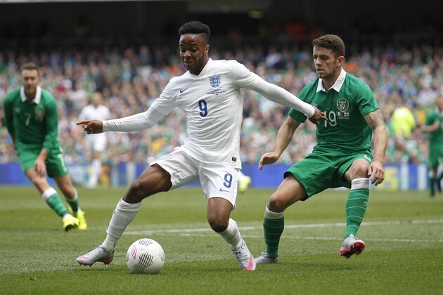 England's Raheem Sterling, left, wins the ball from Republic of Ireland's Robbie Brady during the international  soccer friendly match between Ireland and England, at the Aviva stadium, in Dublin, Ireland, Sunday, June 7, 2015.  (AP Photo/Peter Morrison)