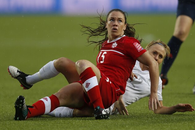 EDMONTON, AB - JUNE 11: Allysha Chapman #15 of Canada and Betsy Hassett #12 of New Zealand fall to the ground during the FIFA Women's World Cup Canada Group A match between China and Netherlands at Commonwealth Stadium on June 11, 2015 in Edmonton, Alberta, Canada.  (Photo by Todd Korol/Getty Images)