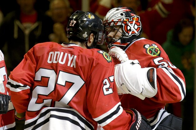 Chicago Blackhawks goalie Corey Crawford, right, and teammate Johnny Oduya, of Sweden, celebrate following the Blackhawks' 2-1 victory over the Tampa Bay Lightning in Game 4 of the NHL hockey Stanley Cup Final Wednesday, June 10, 2015, in Chicago. The series is tied 2-2. (AP Photo/Nam Y. Huh)