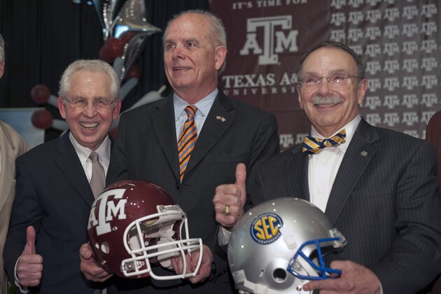 Southeastern Conference commissioner Mike Slive, left, SEC leadership chairman and Florida president Bernie Machen, center, and Texas A&M president R. Bowen Loftin, right pose for a photograph during a celebration of Texas A&M's move to the Southeastern Conference Monday, Sept. 26, 2011, in College Station, Texas. (AP Photo/Dave Einsel)