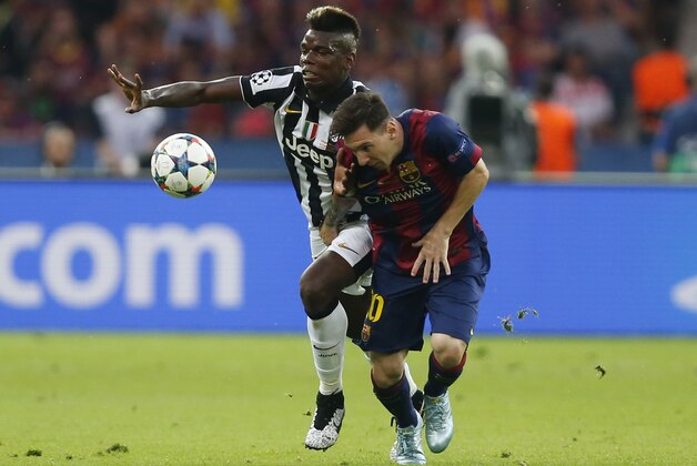 Juventus' Paul Pogba, left, battles for the ball with Barcelona's Lionel Messi during the Champions League final soccer match between Juventus Turin and FC Barcelona at the Olympic stadium in Berlin Saturday, June 6, 2015. (AP Photo/Frank Augstein)