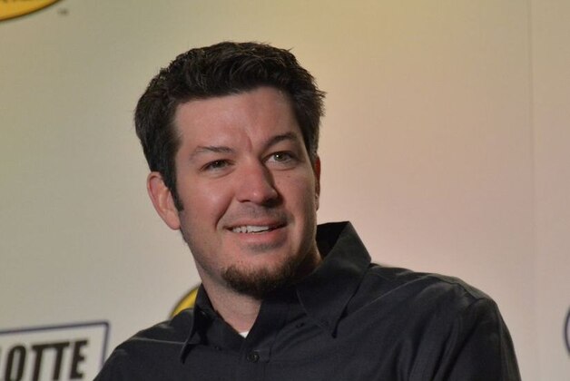 Martin Truex Jr. smiles for media in Charlotte.