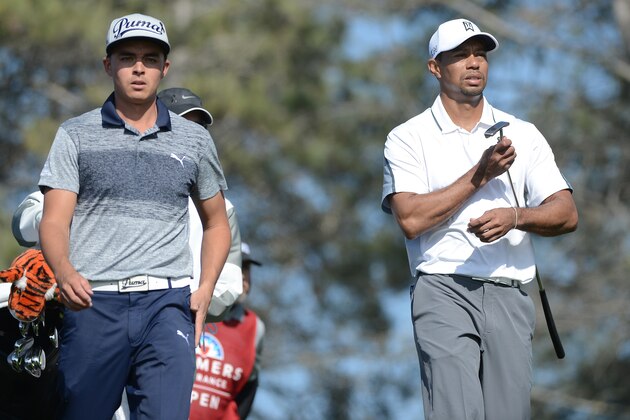 LA JOLLA, CA - FEBRUARY 05:  Tiger Woods (R) and Rickie Fowler (L) walk the fairway on the 17th hole of the north course during the first round of the Farmers Insurance Open at Torrey Pines Golf Course on February 5, 2015 in La Jolla, California.  (Photo by Donald Miralle/Getty Images)